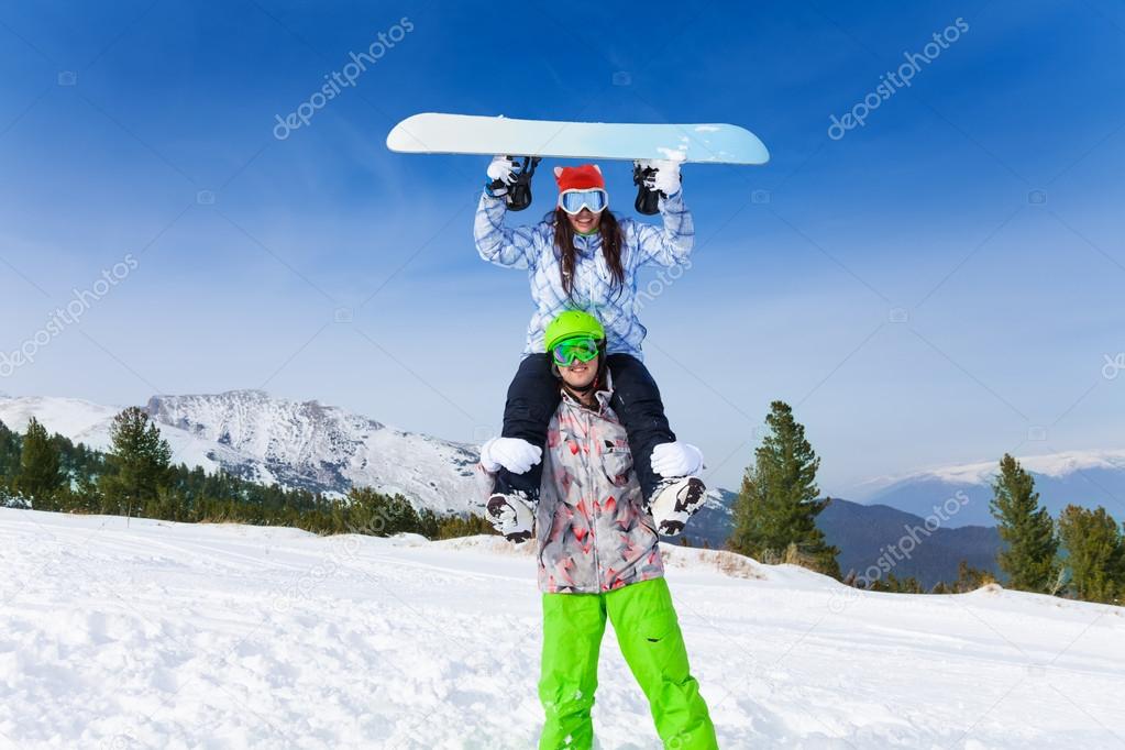 Man in ski mask holding girl