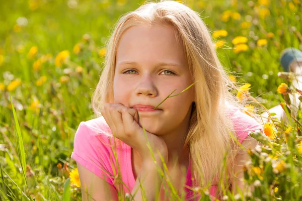 Blond cute girl in yellow flowers portrait — Stock Photo, Image