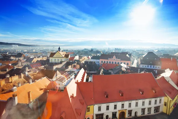 Rode daken en stralende zon in sibiu, Roemenië — Stockfoto