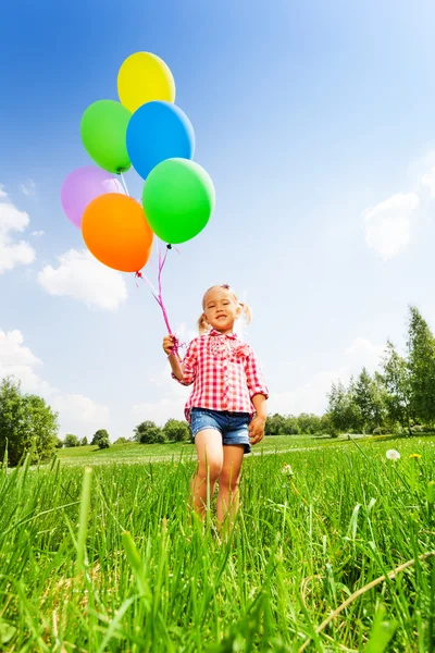 Small blond girl with many balloons in park — Stock Photo, Image