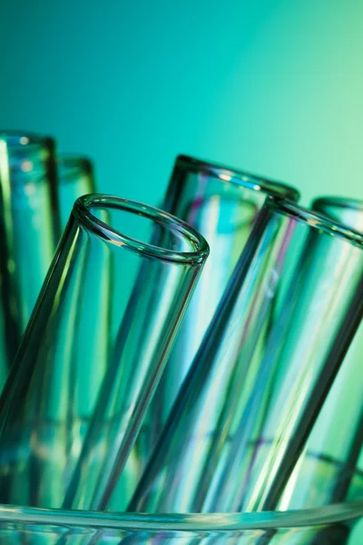 Glass test tubes lighted with blue green light — Stock Photo, Image