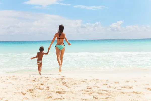 Child and woman running to the sea holding hands — Stock Photo, Image