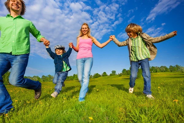 Positive parents walking with boys in park — Stock Photo, Image