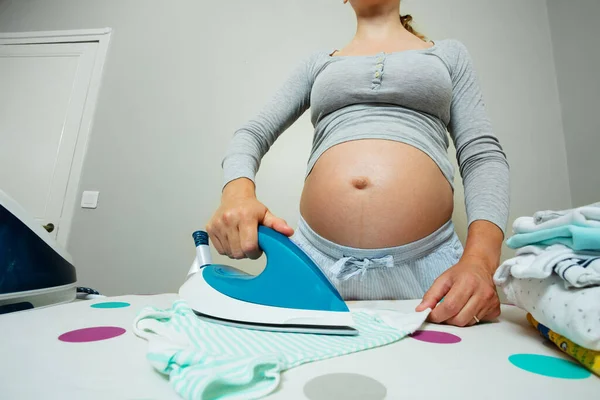 Iron Close Pregnant Woman Ironing Newborn Baby Clothes Preparing Birth — Stockfoto