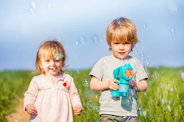 Little Brother Sister Play Soap Bubbles Standing Together Blue Sky — Fotografia de Stock