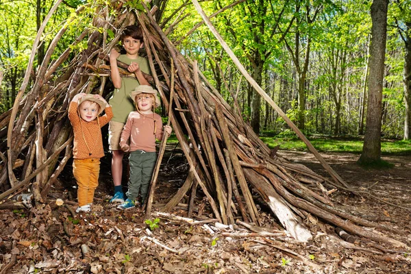 Three Children Boys Girl Pile Brushwood Forest Build Hut Branches — Stockfoto