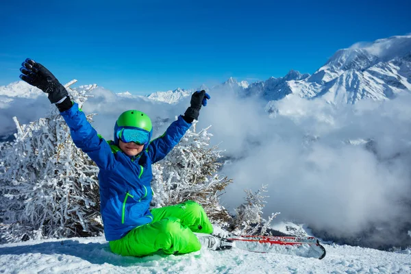 Little Boy Alpine Ski Sit Snow Lifting Hands Wear Helmet — Zdjęcie stockowe