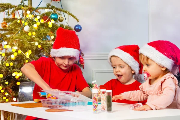 Three Children Two Boys Little Girl Prepare Gingerbread House Decorations — 图库照片