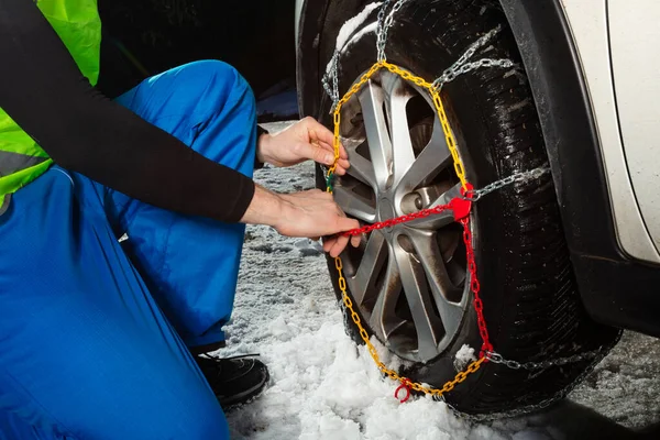 Close Man Hands Putting Chains Car Wheel Icy Road Winter — Fotografie, imagine de stoc