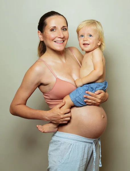 Happy Pregnant Mother Big Belly Holding Little Blond Toddler Hands — Fotografia de Stock