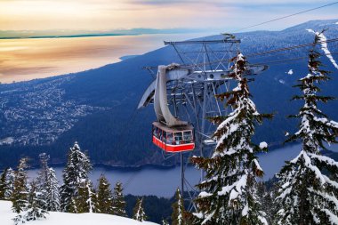 Lift gondola cabin over Vancouver panama and Capilano lake from Grouse Grind in Canada at winter