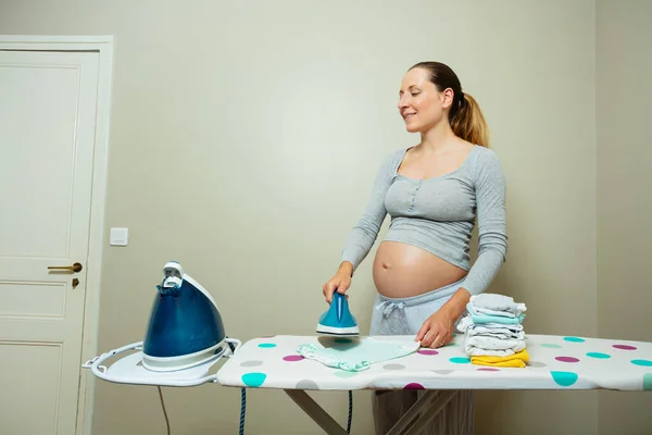 Pregnant Woman Iron Newborn Baby Clothes Preparing Birth Child — Φωτογραφία Αρχείου