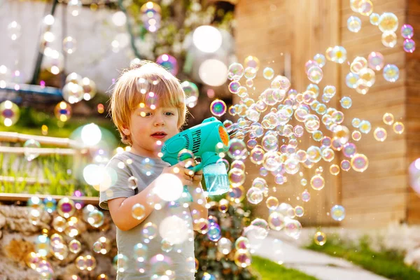 Blond Little Boy Play Soap Bubbles Gun Backyard Garden — Stock Photo, Image