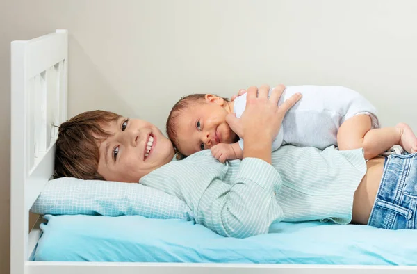 Laughing Smiling Young Positive Boy Lay Bed Hugging Newborn Sister — ストック写真