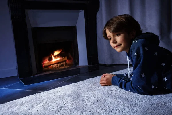 Boy Lay Front Fireplace Carpet Looking Fire Home — Stockfoto