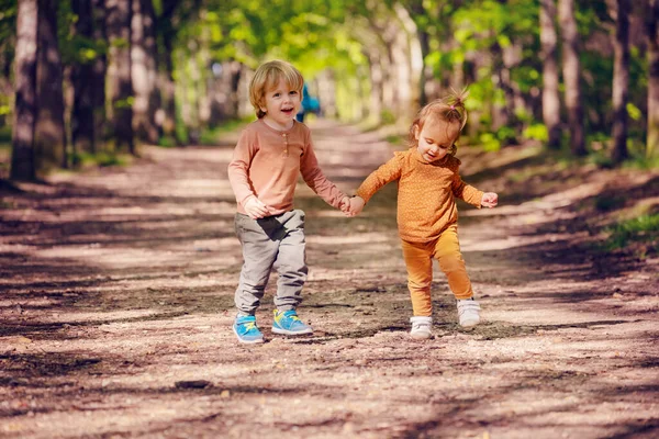 Two Small Kids Blond Boy Girl Run Smiling Holding Hands — 图库照片