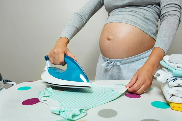 Pregnant Woman Ironing Newborn Baby Clothes Preparing Birth Child Close — 스톡 사진