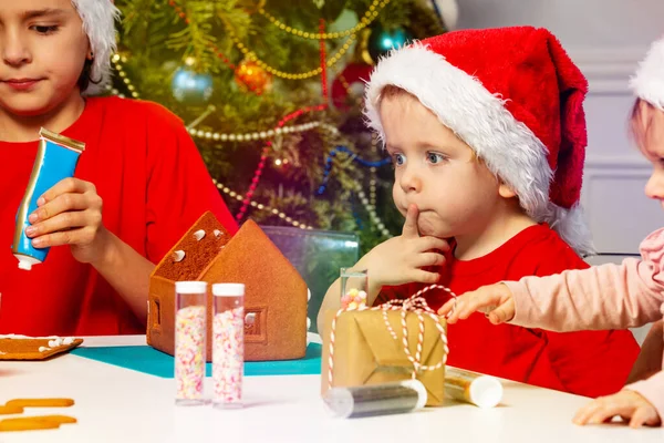 Thoughtful Little Toddler Boy Santa Hat Hold Finger Mouth Construct — Stockfoto
