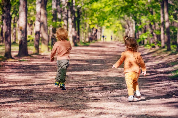 Two Little Kids Blond Boy Girl Run Alley Park Summer Stock Snímky