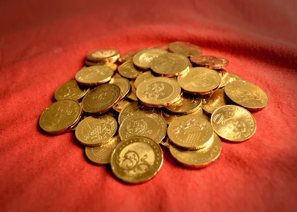 Coins over red background — Stock Photo, Image