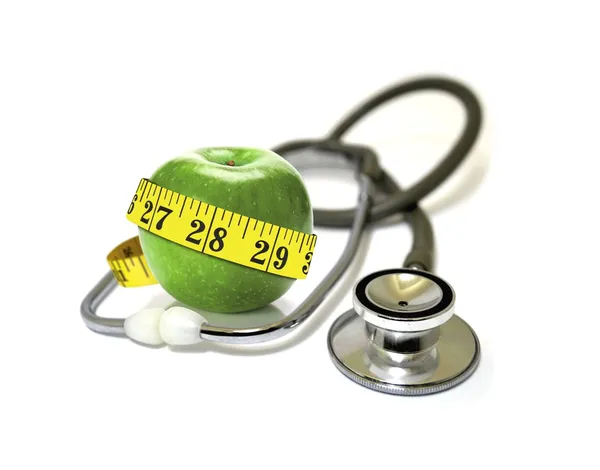 Stethoscope with green apples and measurement tape — Stock Photo, Image