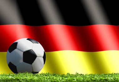 Futbol topu ile Almanya bayrağı çimenlerin üzerinde