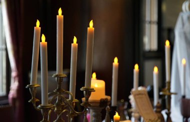 Mum tezgahında yanan bir çok mumun ışığı                               