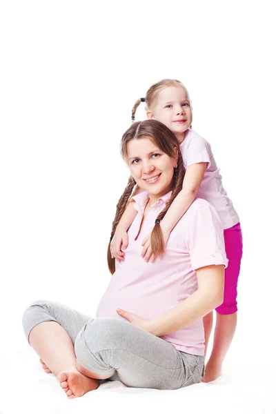 Schöne schwangere Frau mit ihrer Tochter. — Stockfoto