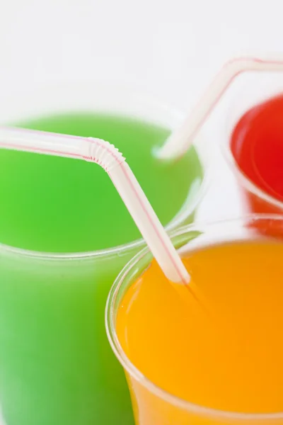 Closeup fruity drinks with straws