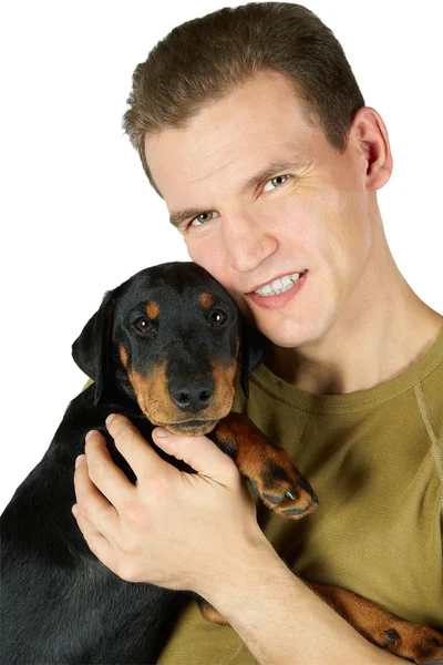 The man in a green t-shirt embraces a puppy of a Jagdterrier, a — Stock Photo, Image