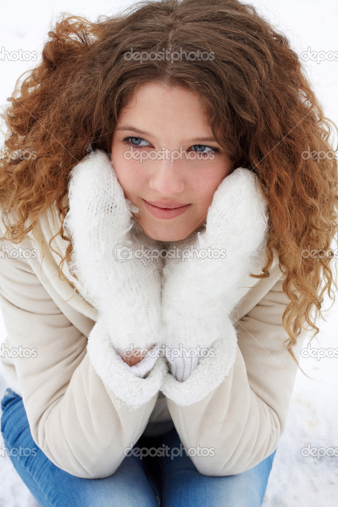 The long-haired girl, smiling, thoughtfully looks aside
