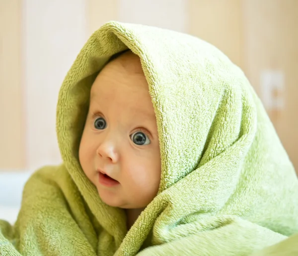 Baby with green towel — Stock Photo, Image