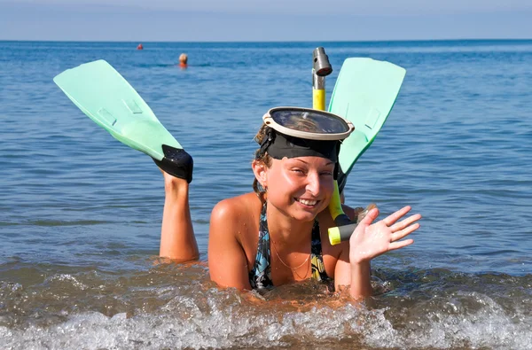 Mädchen mit Flossen und Maske liegt im Meer — Stockfoto