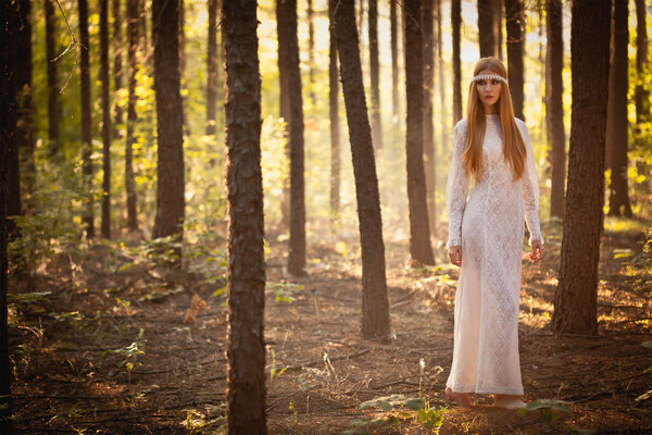 Fairy woman wearing long dress walking at forest
