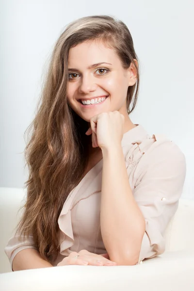 Woman sitting on sofa — Stock Photo, Image