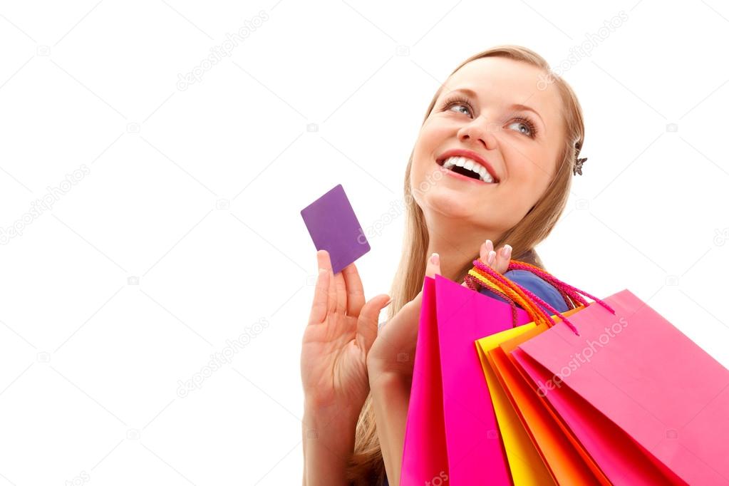 Woman holding shopping bags and card