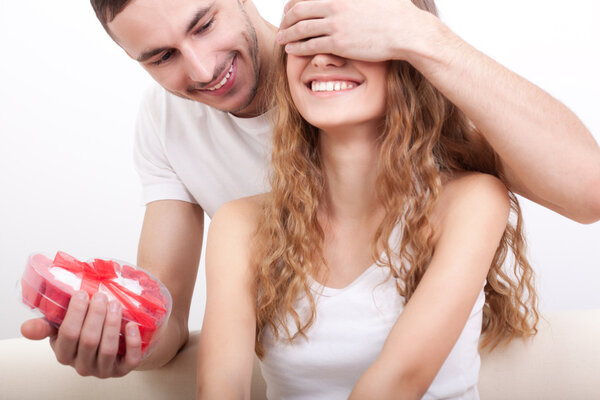 Man giving heart-shaped box for his girlfriend