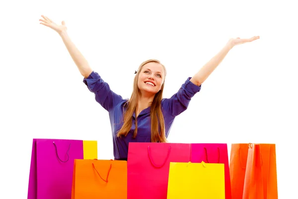 Mujer feliz de pie detrás de bolsas de compras —  Fotos de Stock