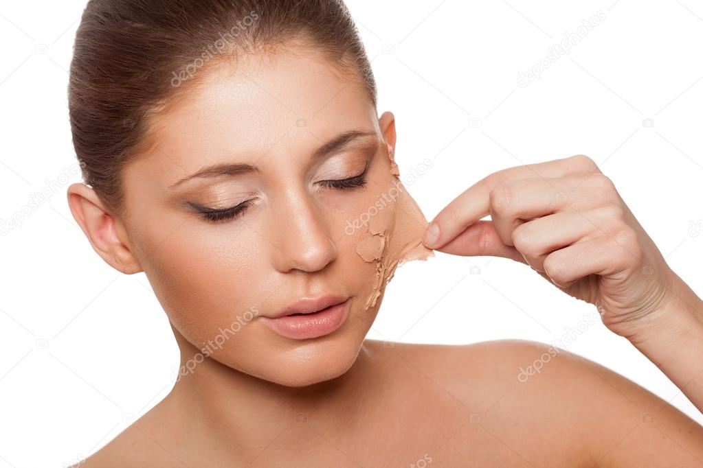 Woman taking of her old skin from face