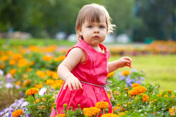 Malá holčička v oranžové květy — Stock fotografie