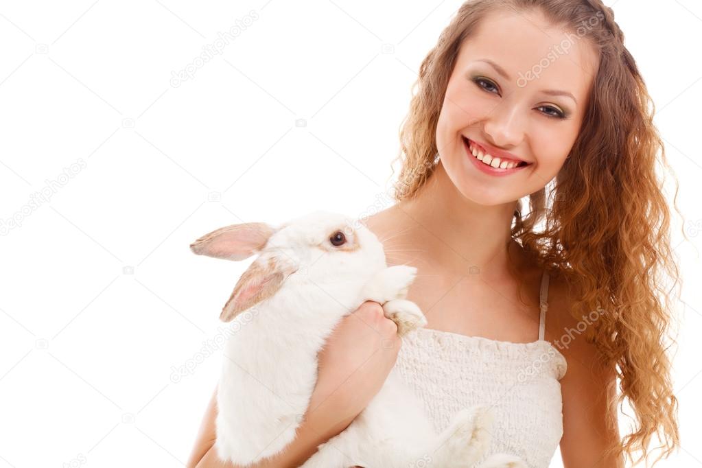 Happy woman holding rabbit