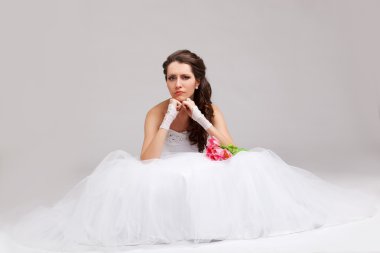 Beautiful bride sitting on the floor clipart