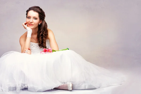 Beautiful bride sitting on the floor — Stock Photo, Image