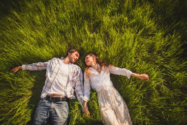 Couple in love lying on grass clipart