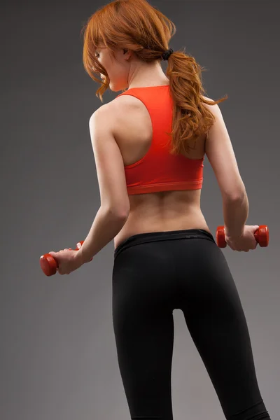 Woman exercising with dumbbells — Stock Photo, Image