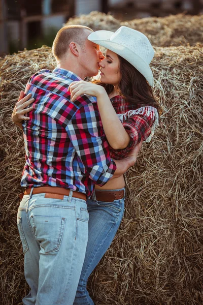 Paar küsst sich in der Nähe von Heu — Stockfoto
