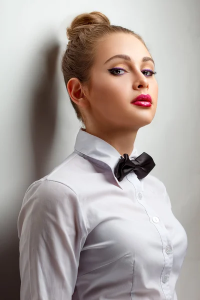 Blondie woman in white shirt and black bow-tie — Stock Photo, Image