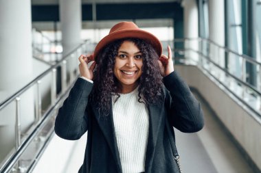 Geçiş bölgesindeki genç kadın kameraya gülümsüyor.