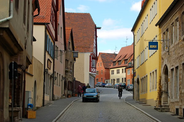 Examples of restoration of buildings dating back to the mid eighteenth century on a cobblestoned street in Rotheburg,Germany