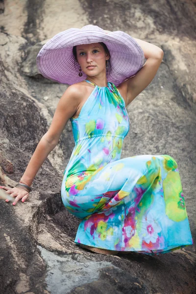 Brunette girl in flower dress and pink hat — Stock Photo, Image